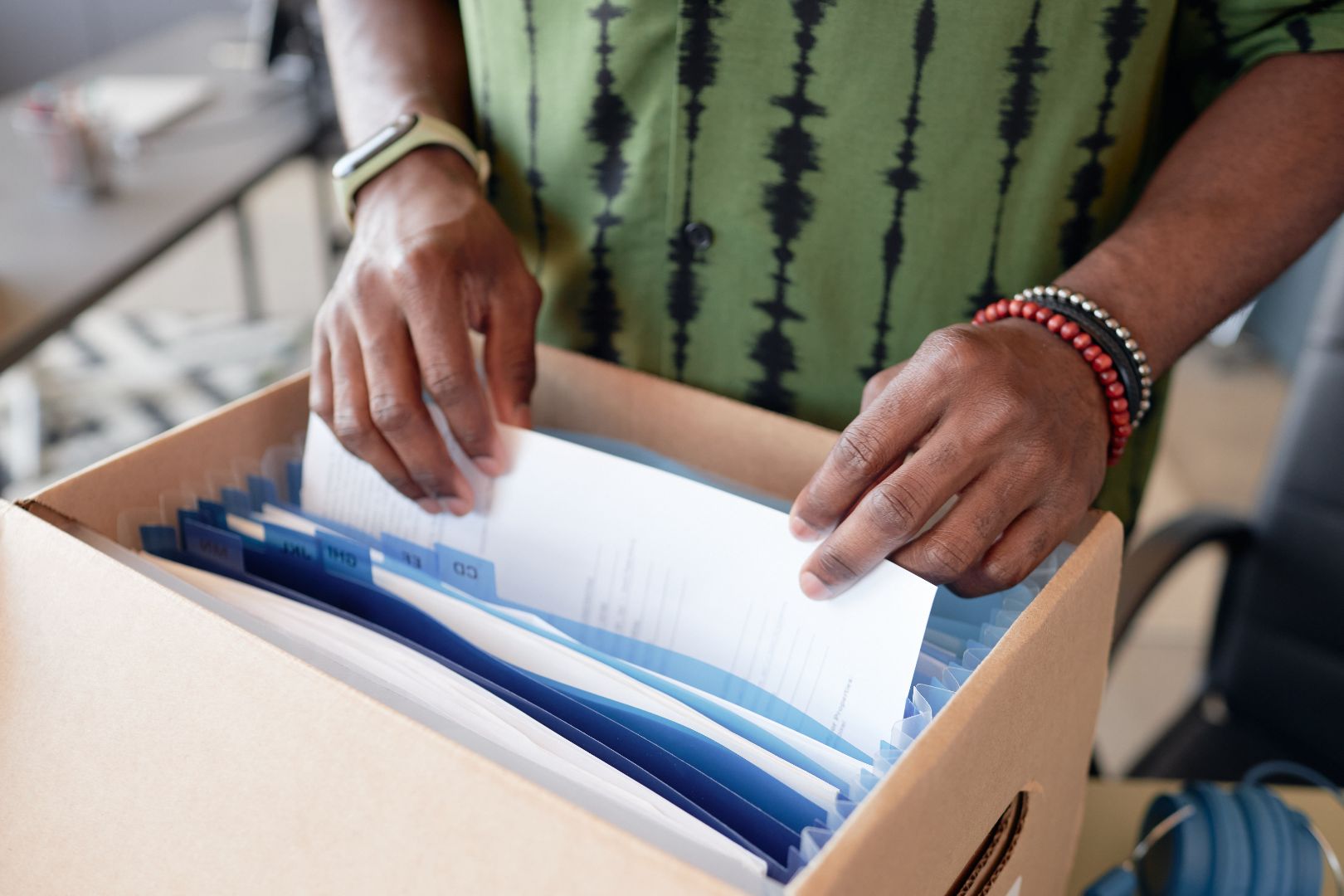 Close up of male hands sorting documents in a folder