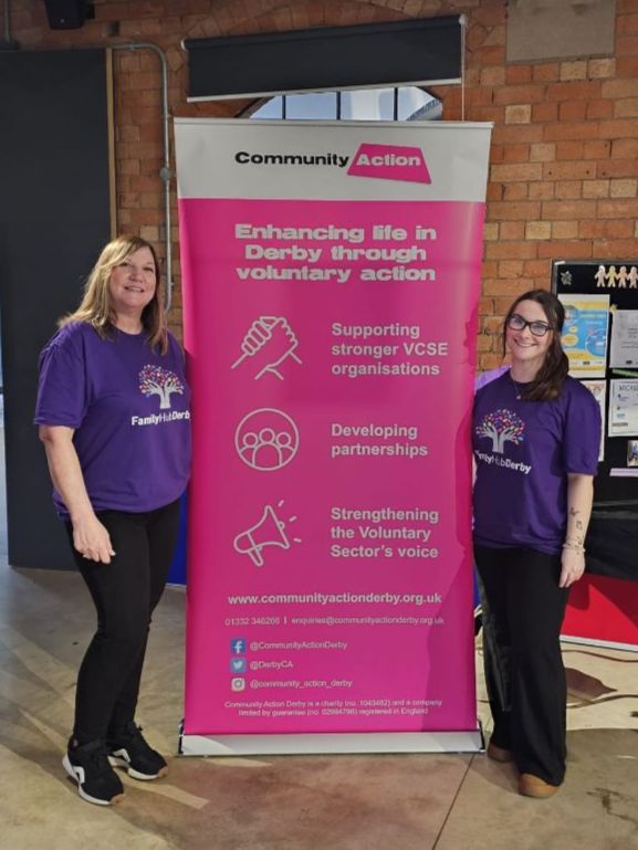 Helen and Rebecca at the Community Action banner